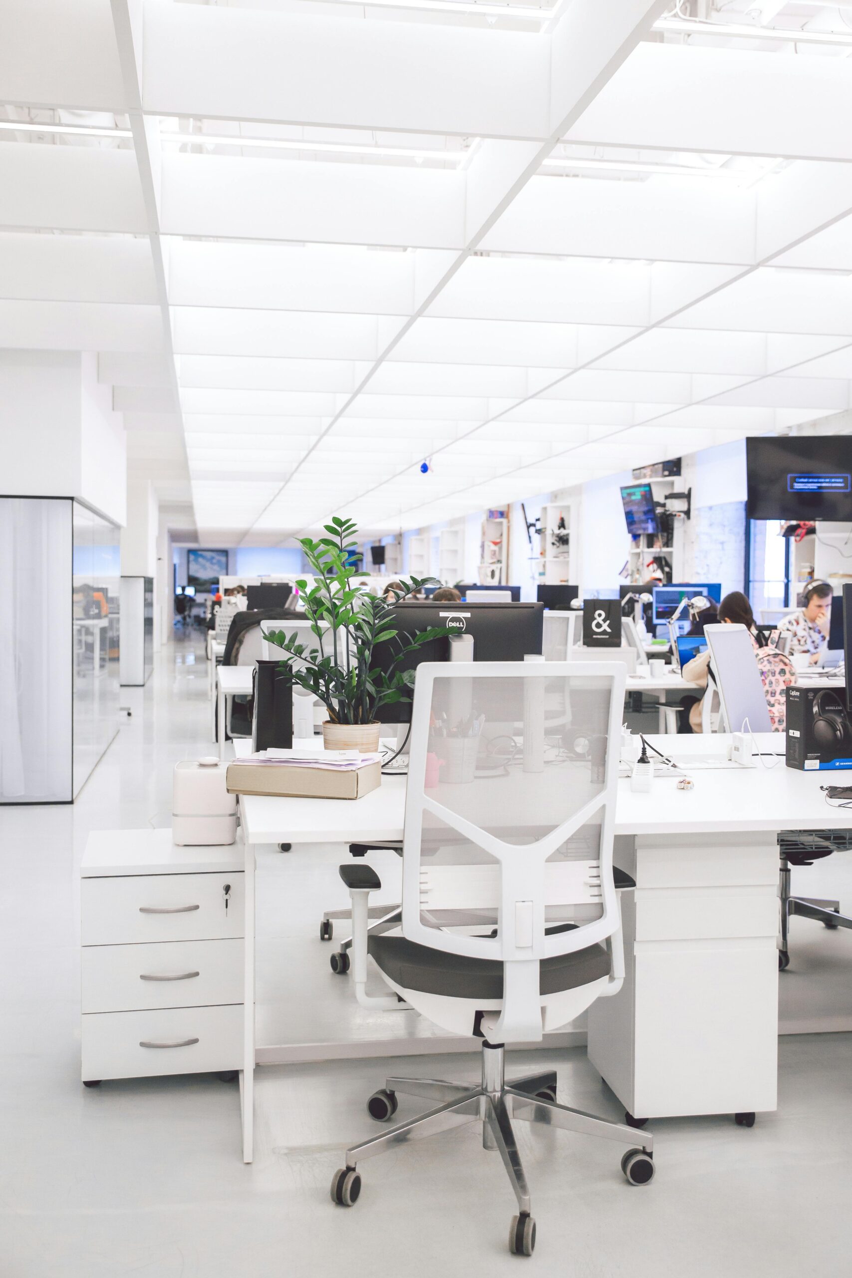 Image of an office with people sitting at computers