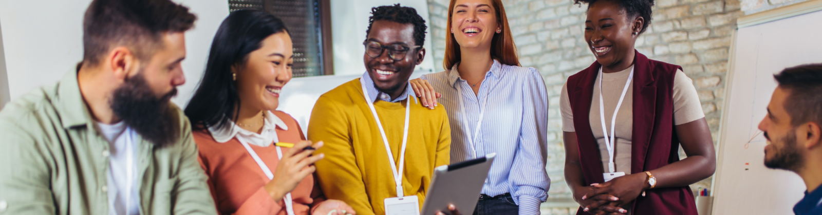 People in an office laughing and smiling