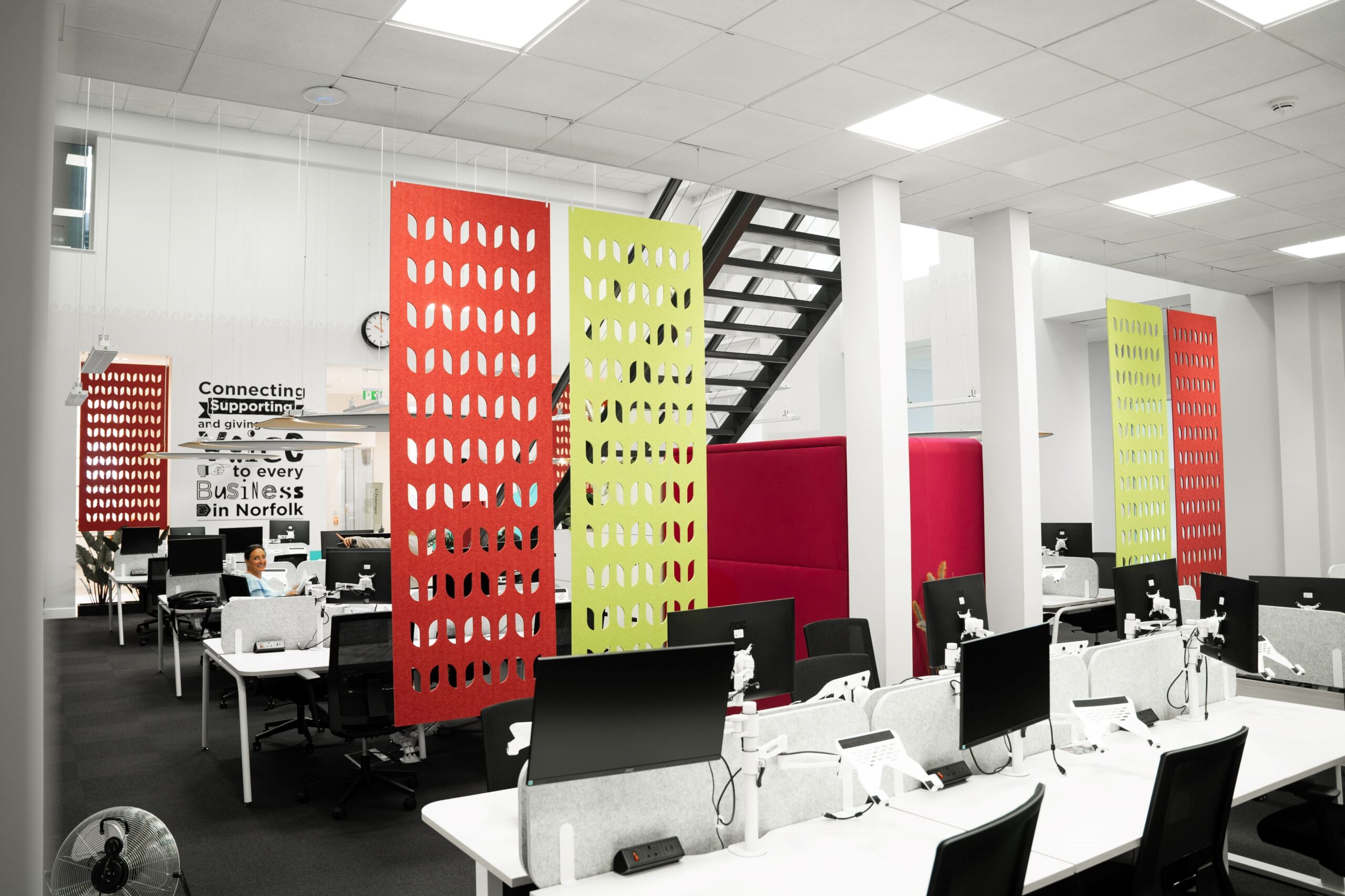 An image of desks, computer monitors, chairs and acoustic screens in Norfolk Chambers of Commerce's Business Hub